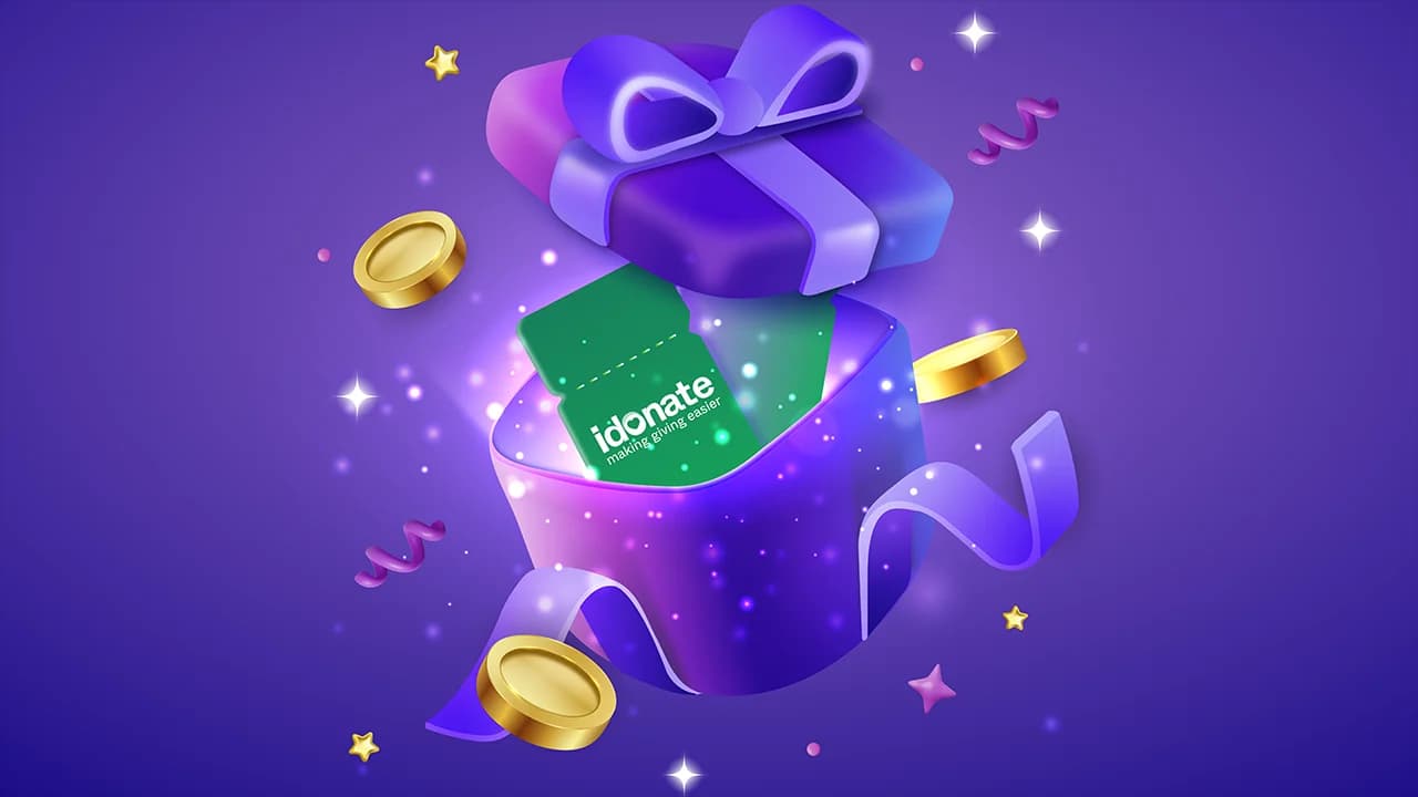 Purple gift box with an iDonate raffle ticket, coins and confetti